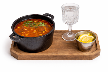 Borscht served with traditional accompaniments and bread