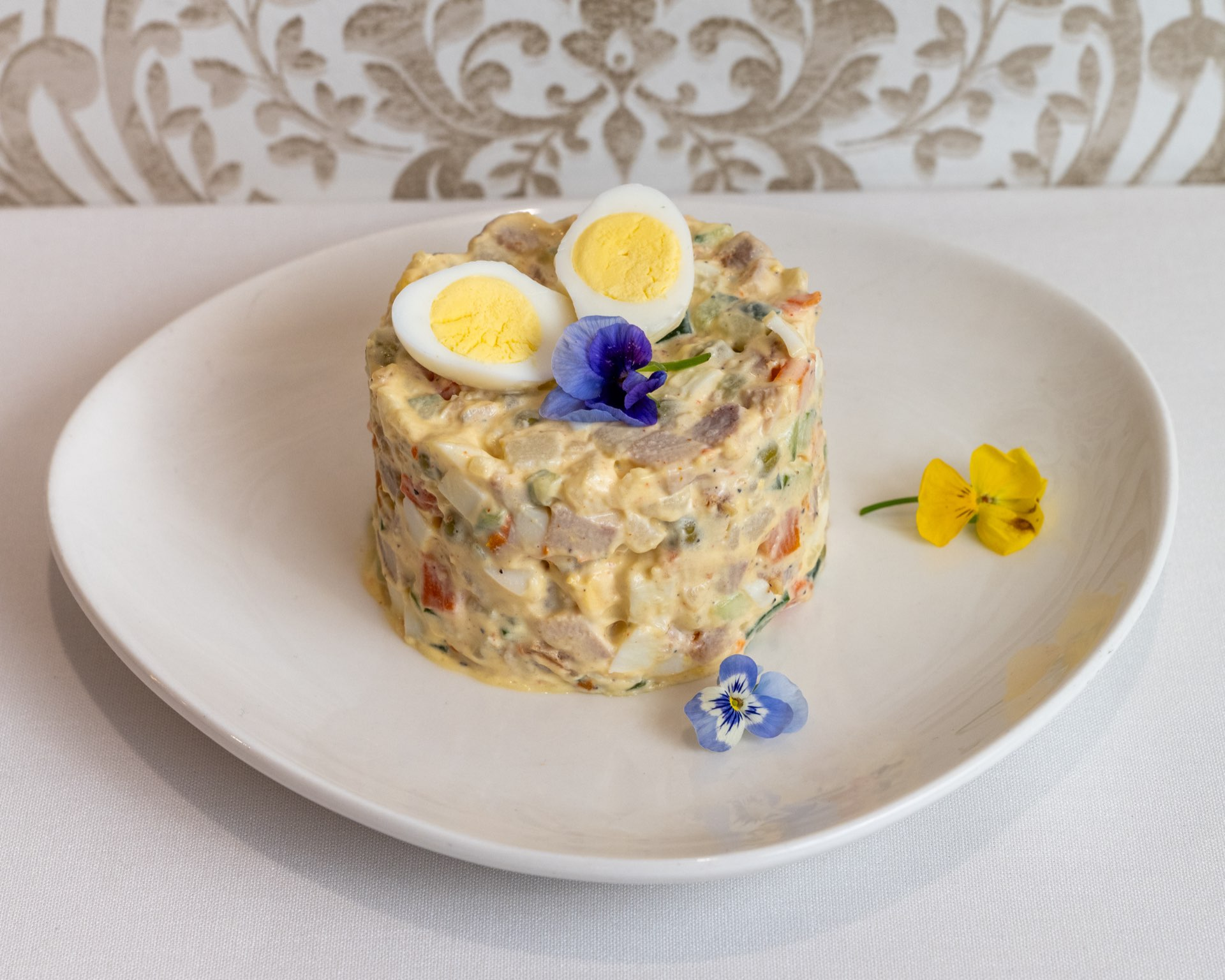 Traditional herring salad with hard-boiled eggs and fresh herbs
